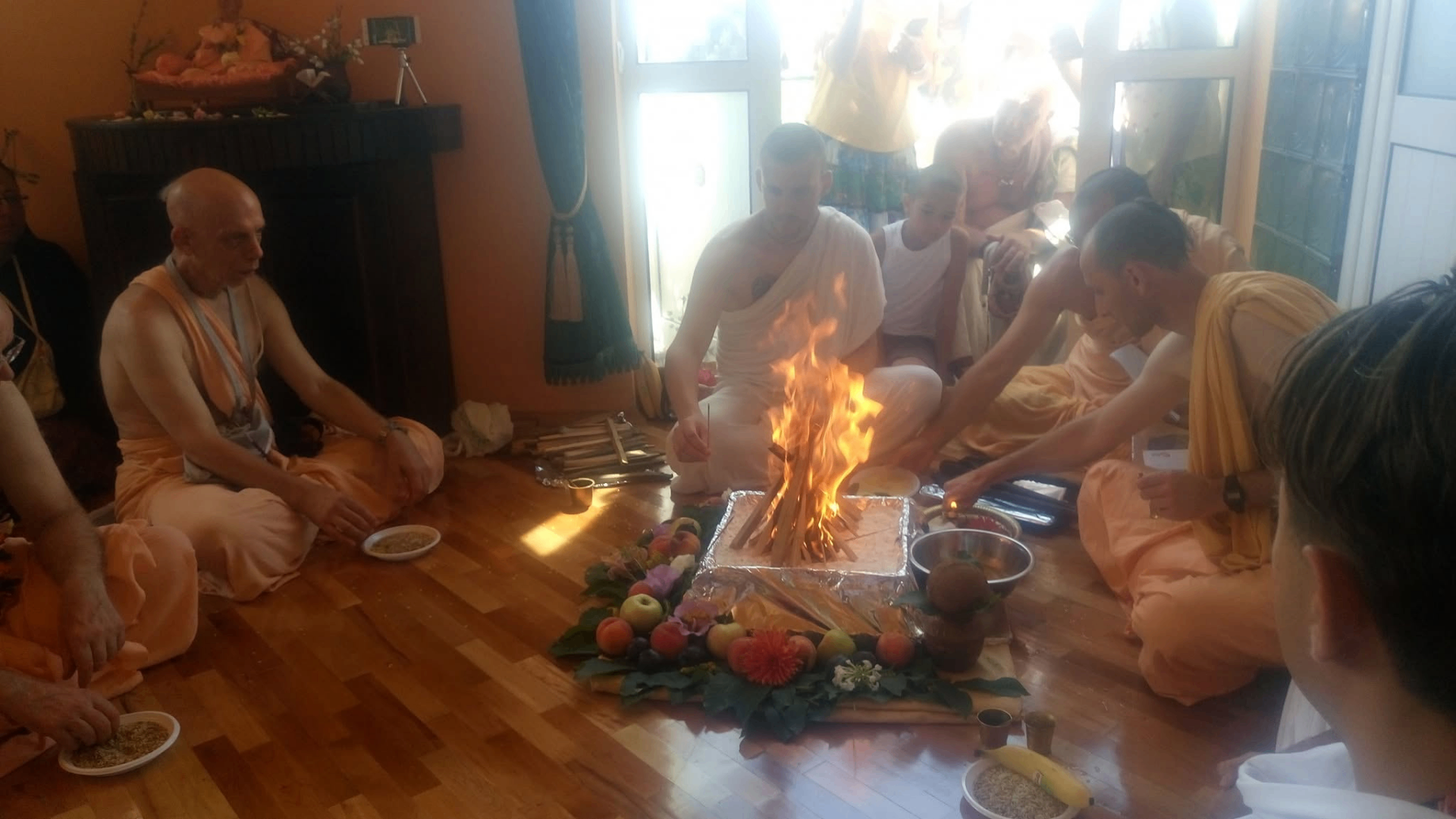 Priests offering grains and ghee into the yajña fire