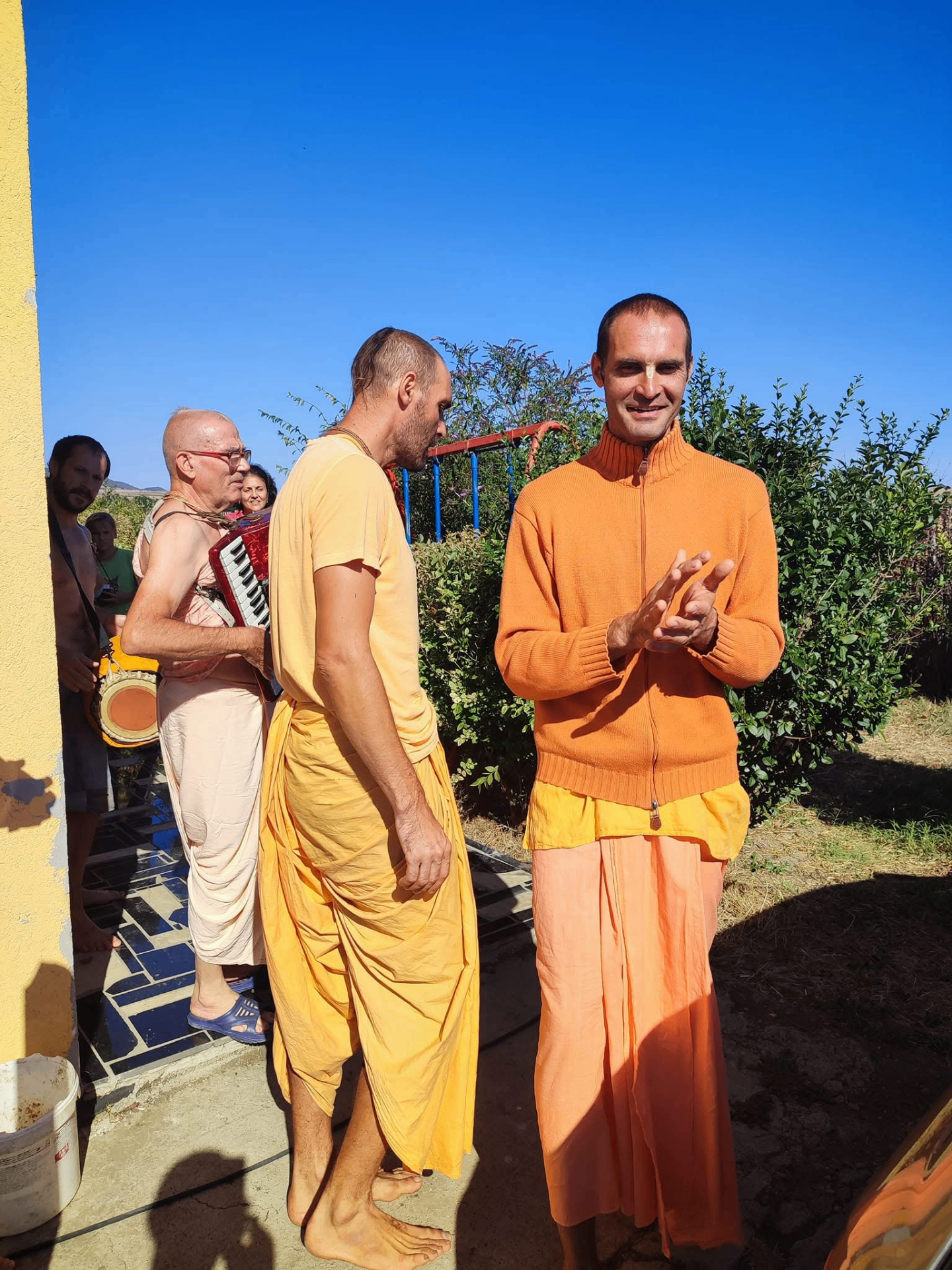 Devotees singing outside in the morning sun