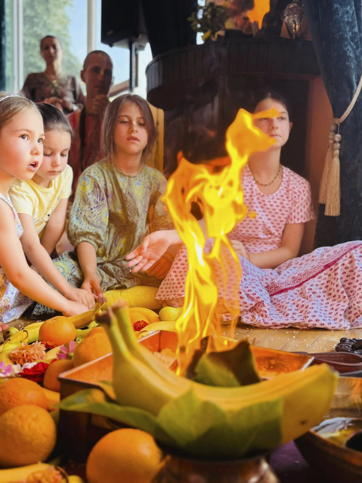 Children at the sacred fire yajña — offering fruits and grains to Krishna