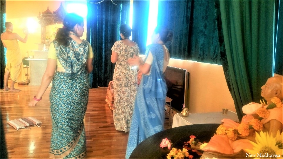 Devotees before the altar in the temple room